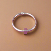 Silver bracelet on a pink background